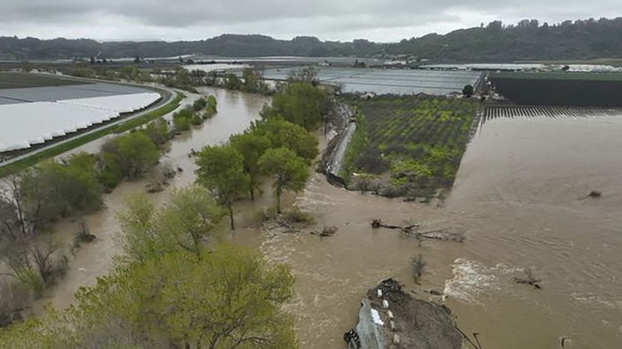 A breached levee and flooded river are seen Sunday in Pajaro, California.