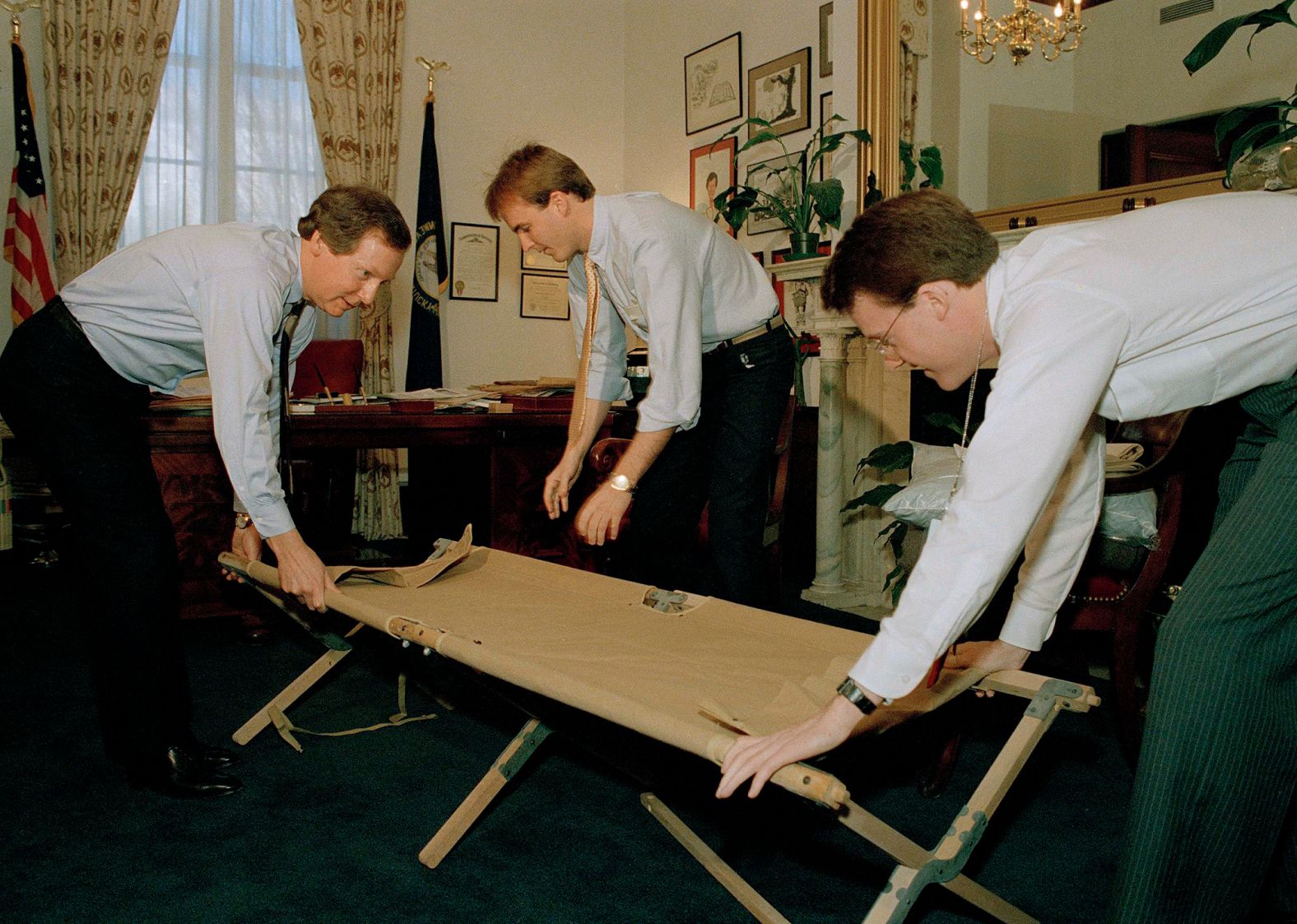 McConnell, left, and aides Steve Johnson, center, Mike Mitchell set up a cot in the senator's office as they prepare for another night of a Senate filibuster in February 1988. Republicans were filibustering against campaign spending legislation.