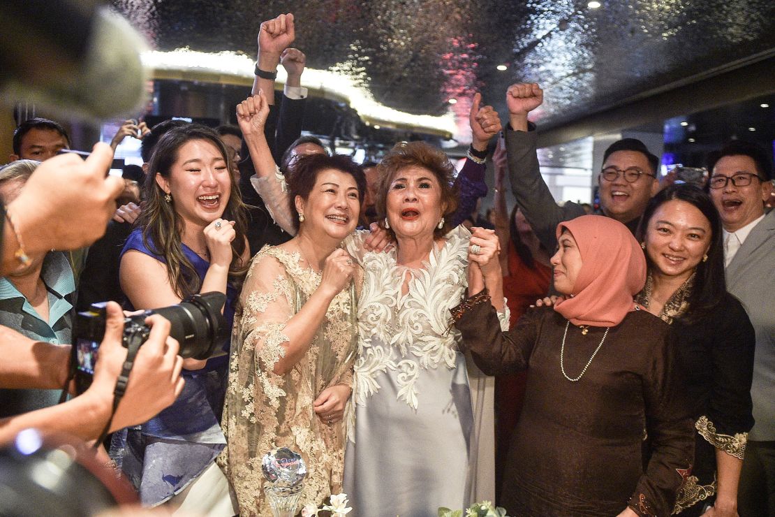 Janet Yeoh (centre R), mother of actress Michelle Yeoh, celebrated her daughter's historic Oscar win on Sunday. 