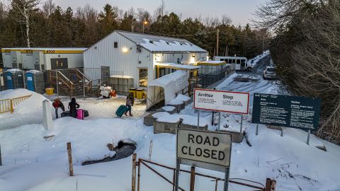 This aerial view shows migrants from Venezuela, Nigeria, Haiti and other countries arriving at the Roxham Road border crossing in Roxham, Quebec, on March 3, 2023.