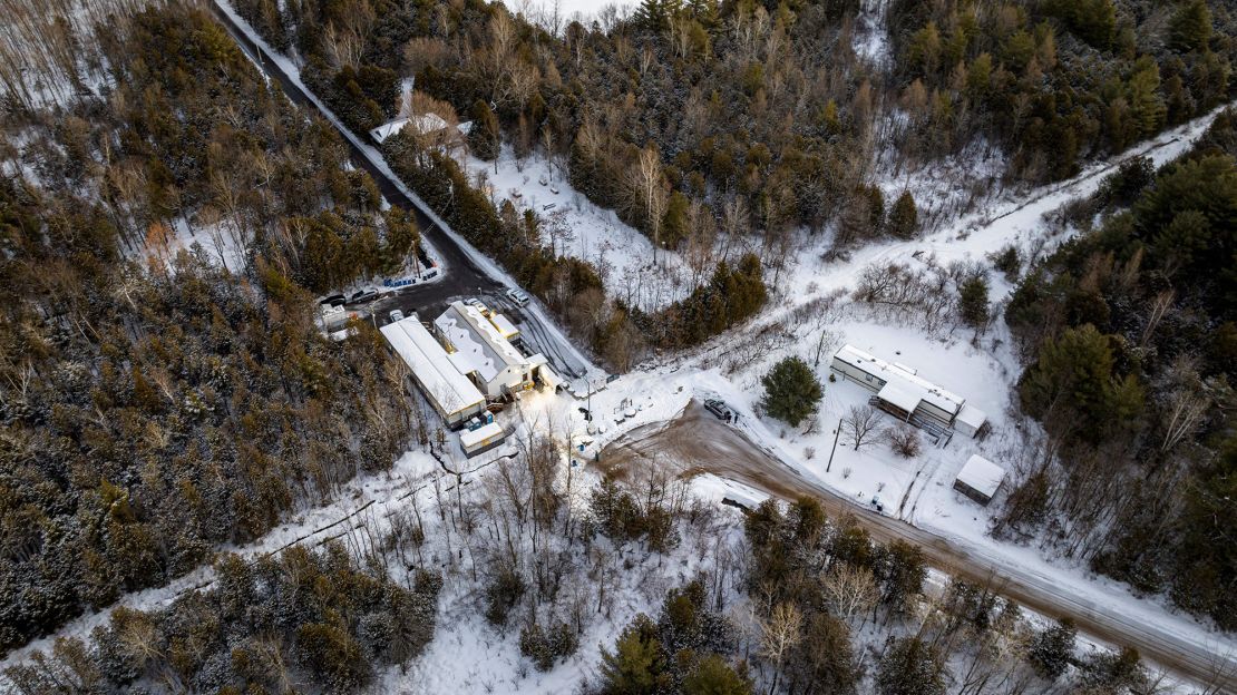 This aerial view shows migrants from Venezuela, Nigeria, Haiti and other countries arriving at the Roxham Road border crossing in Roxham, Quebec, on March 3, 2023.