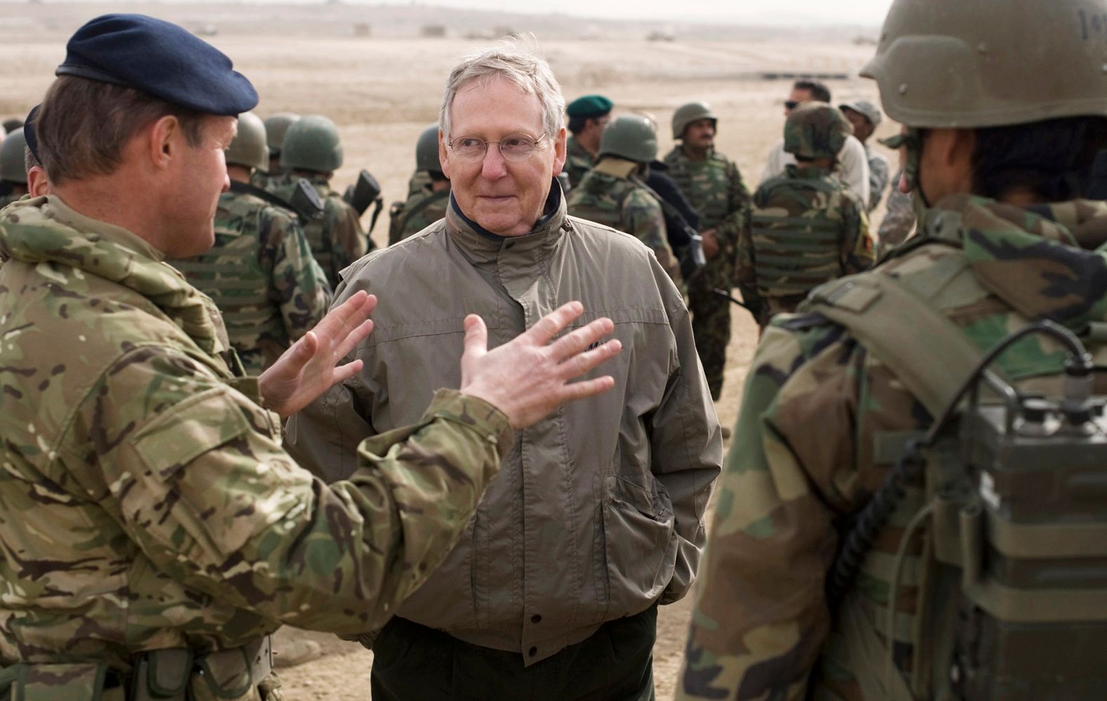McConnell speaks to a NATO training mission adviser as he visits a military training cernter in Kabul, Afghanistan, in January 2011.