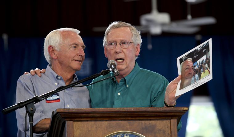 In August 2015, McConnell holds up a selfie photo that he took with Kentucky Gov. Steve Beshear, left, the year before. McConnell reminded Beshear that he falsely predicted that McConnell would lose his Senate race and retire. McConnell signed the photo for Beshear, who was term-limited and would be leaving office before him.