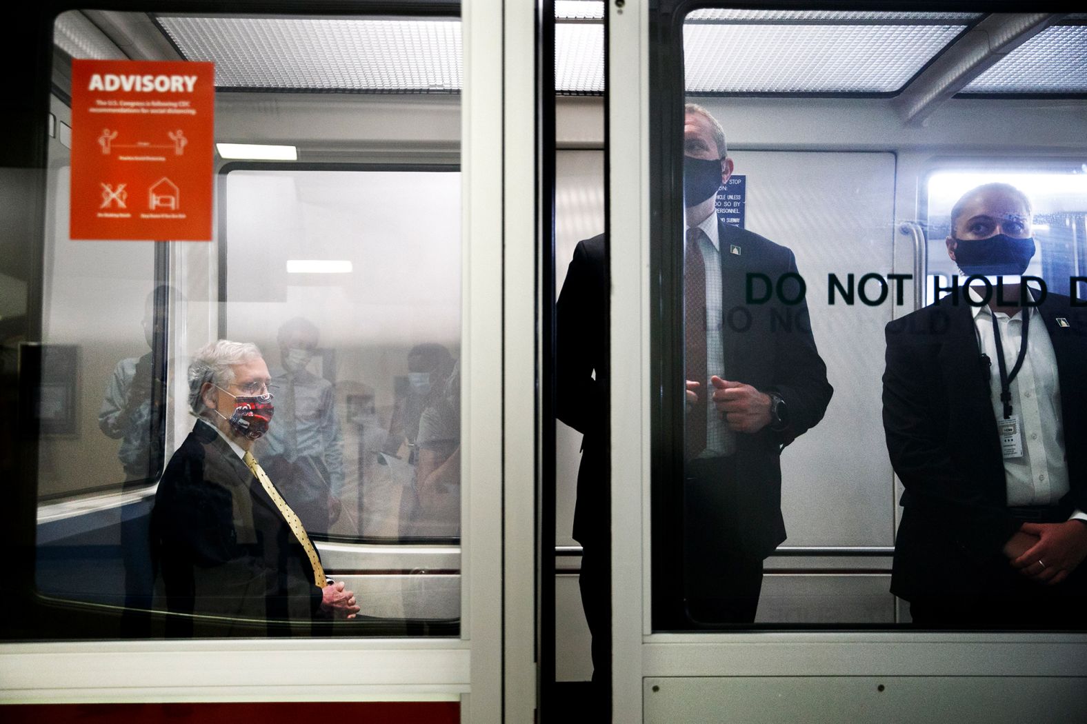 McConnell, left, rides the Senate subway between meetings in July 2020.