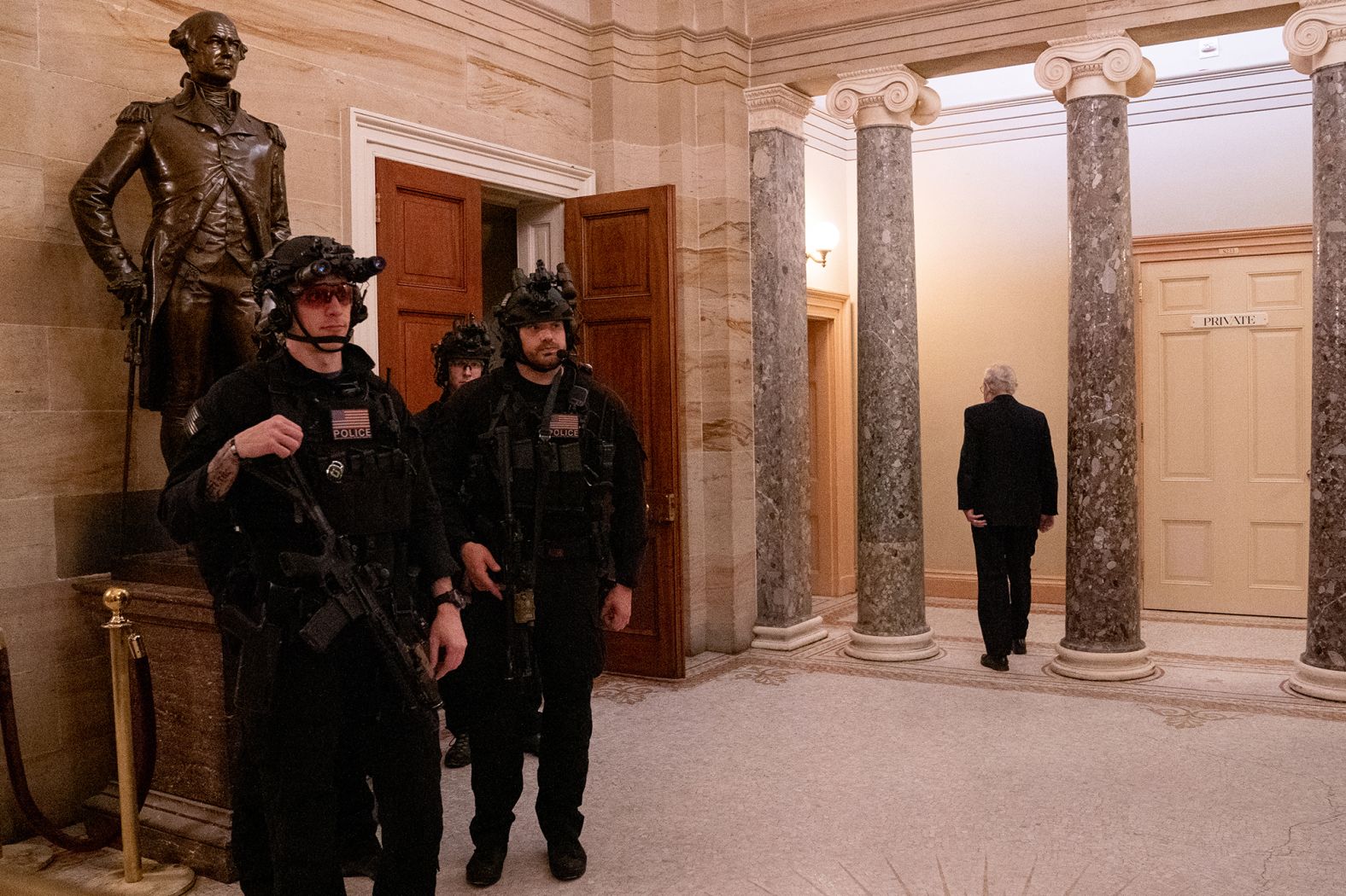 McConnell, right, walks past armed police at the US Capitol after <a href="index.php?page=&url=http%3A%2F%2Fwww.cnn.com%2F2022%2F01%2F03%2Fpolitics%2Fgallery%2Fjanuary-6-capitol-insurrection%2Findex.html" target="_blank">the riot on January 6, 2021</a>. 