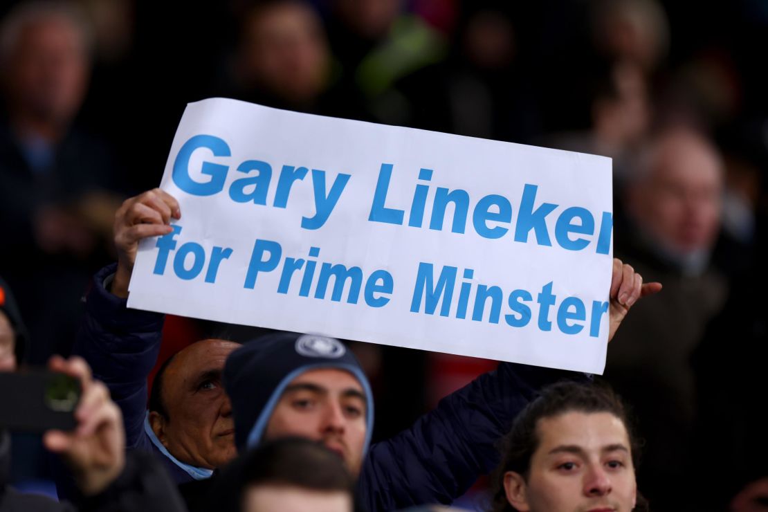 A fan holds a banner supporting Lineker during Saturday's Premier League match between Crystal Palace and Manchester City. Lineker has a long history of sharing political opinions with his 8.8 million Twitter followers.