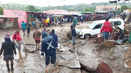 People line a muddy road in this image Tweeted by Malawi Red Cross Society on March 13.