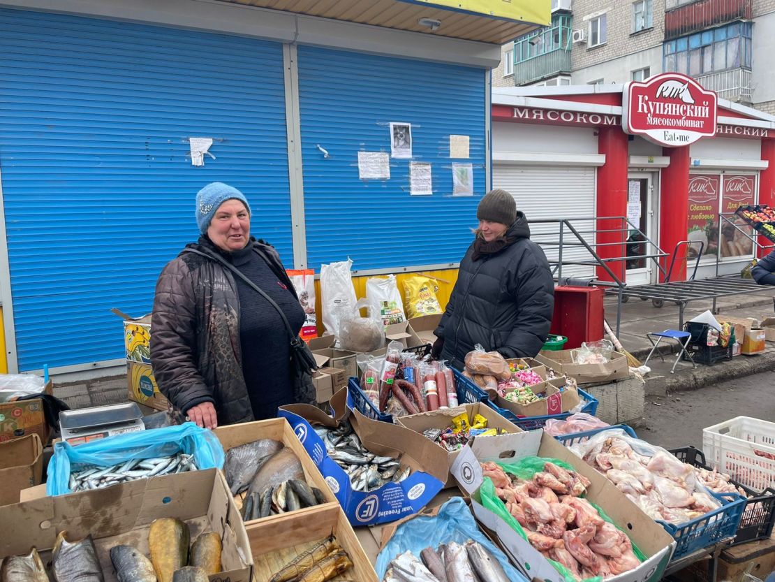 Lida, seen at her makeshift market stall, says she will stay in the city and hide where she despite the continued shelling.  