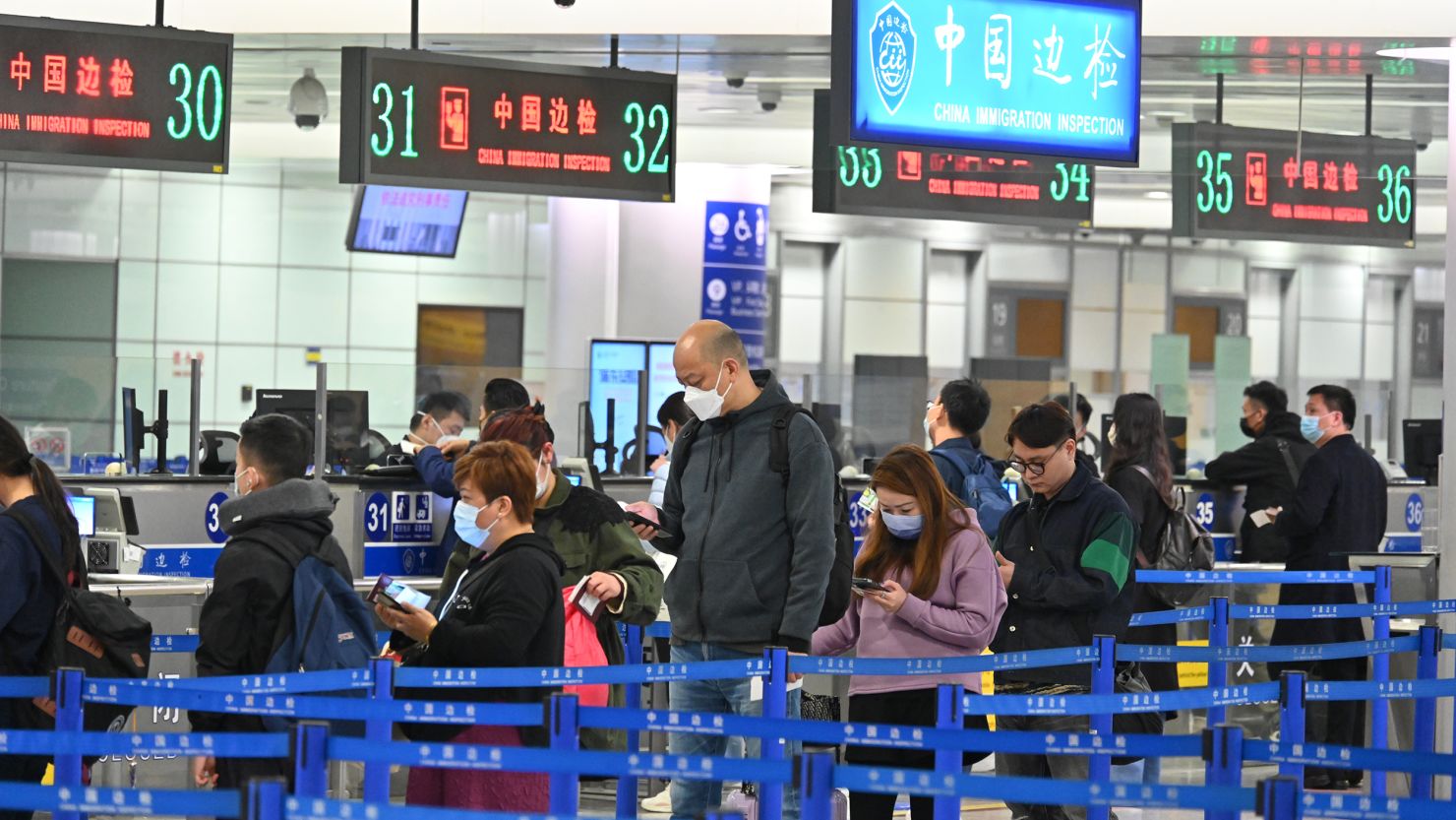 Travelers queue up to go through passport control at Shanghai Pudong International Airport on March 12, 2023 in Shanghai, China.