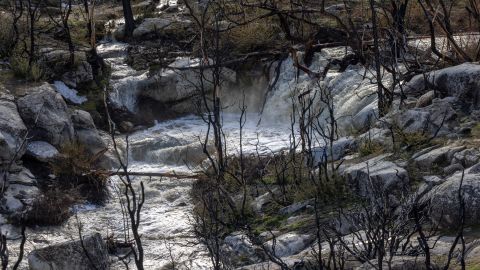 Snowmelt water rushes from mountains burned in the 2021 French Fire on March 12, 2023 near Wofford Heights, California.