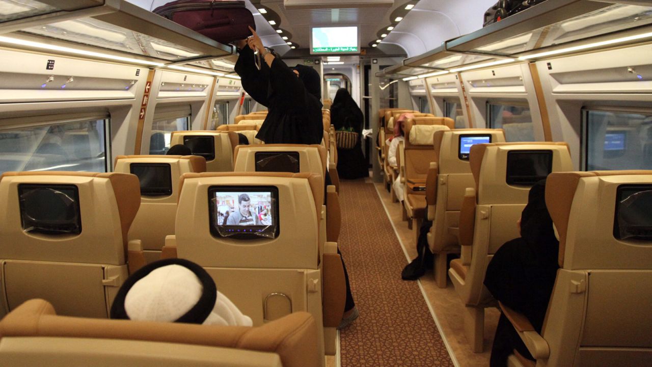 Business class passengers on the train can watch seat-back TVs.