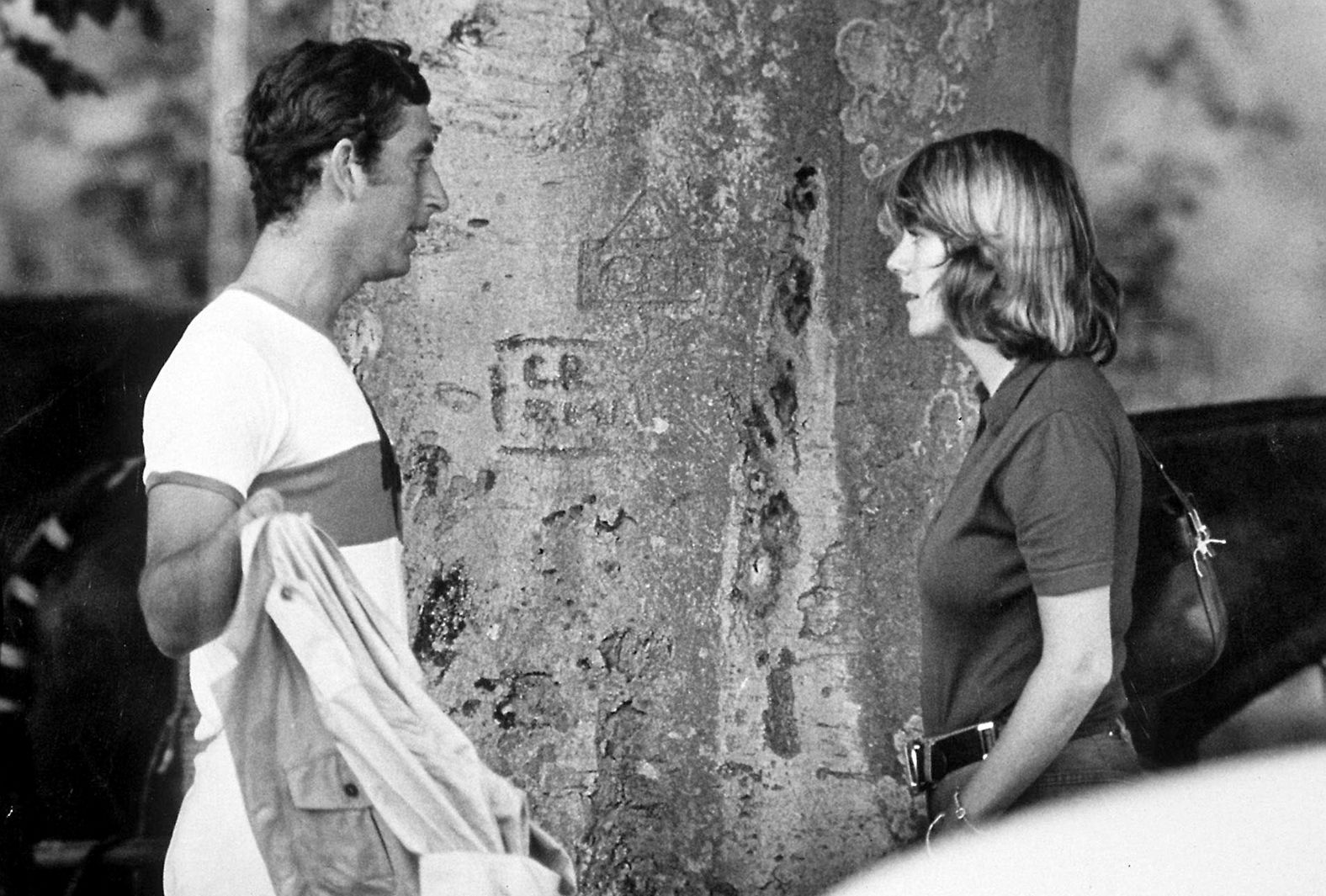 Charles and Camilla talk at a polo match in July 1975.