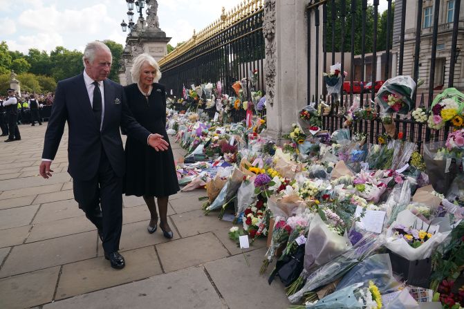 Charles and Camilla view tributes for Queen Elizabeth II that were left outside Buckingham Palace.