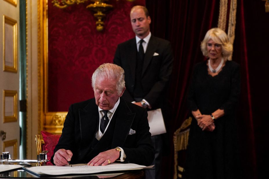 Charles signs an oath to uphold the security of the Church in Scotland during a meeting of the Accession Council in London that proclaimed him as the new King.