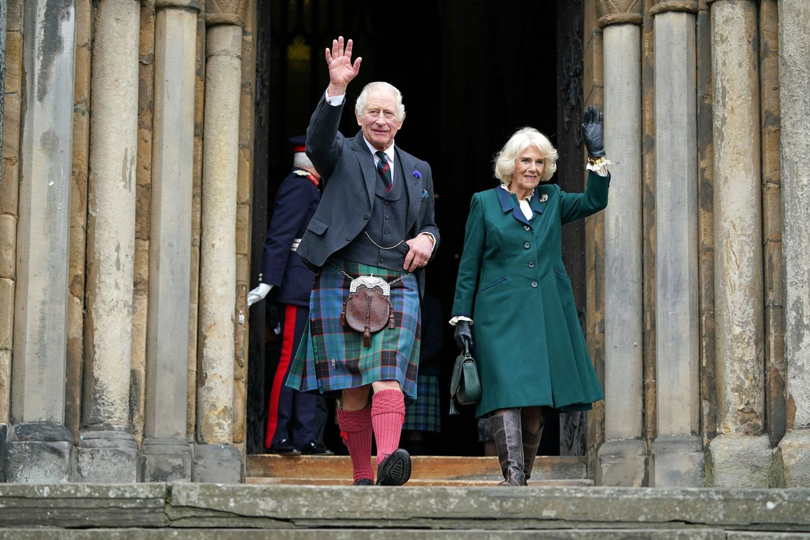 Charles and Camilla wave as they leave Dunfermline Abbey in Scotland during a visit in October 2022.