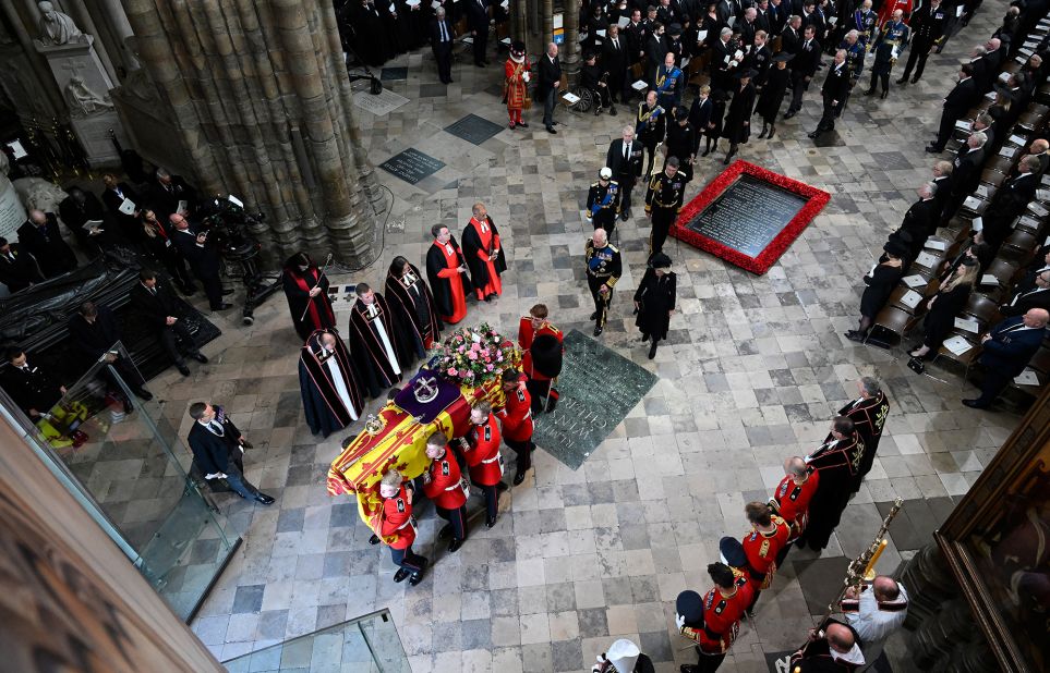 Charles and Camilla walk behind the Queen's coffin as it is carried out of Westminster Abbey.
