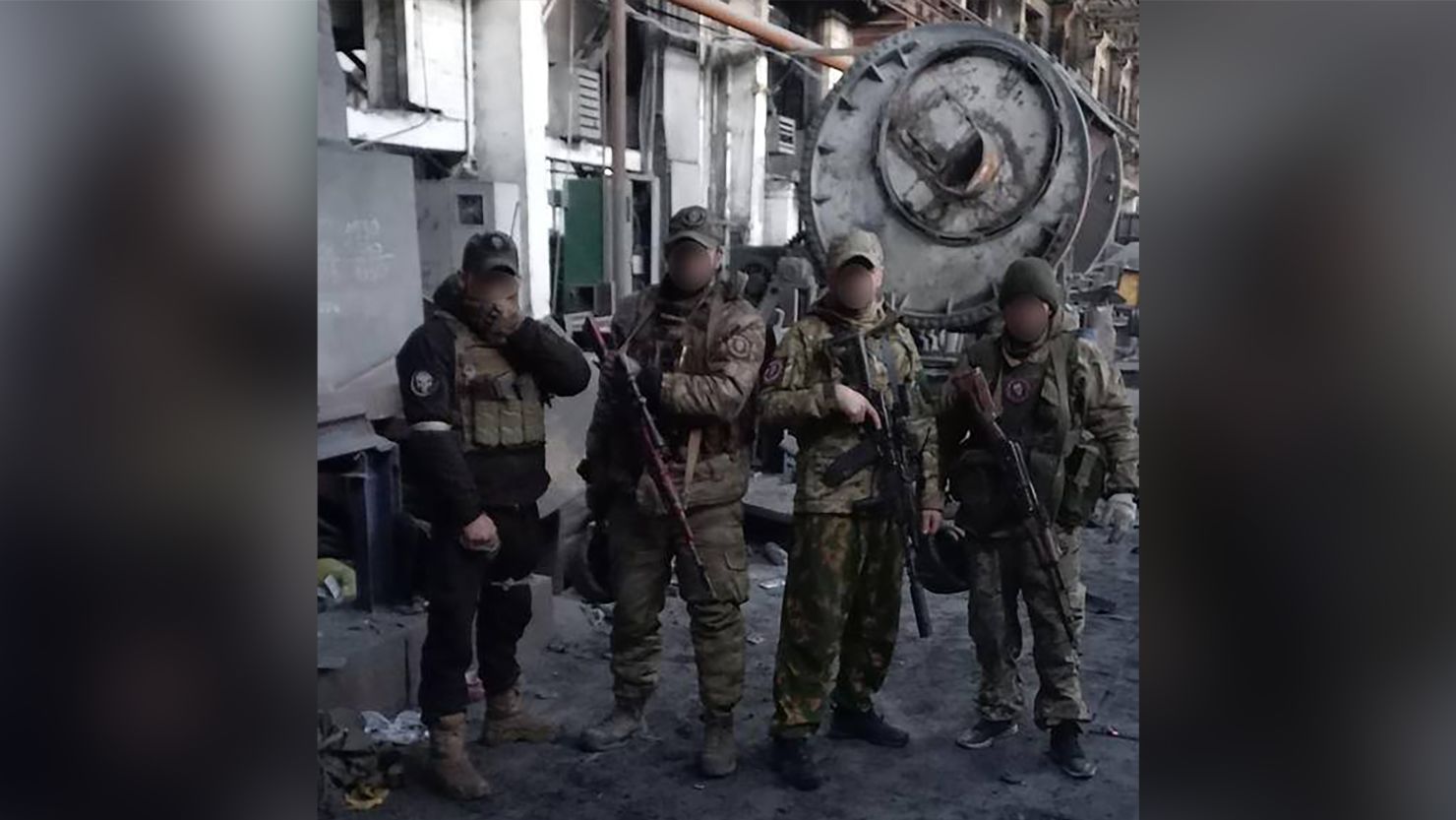 Fighters from the Wagner private military company pose for photographs in what appears to be a workshop within the AZOM metallurgical plant in Bakhmut, Ukraine in this file image. 