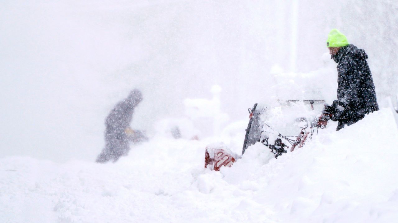 Neighbors clear their driveways in near whiteout conditions on Tuesday in East Derry, New Hamphsire.