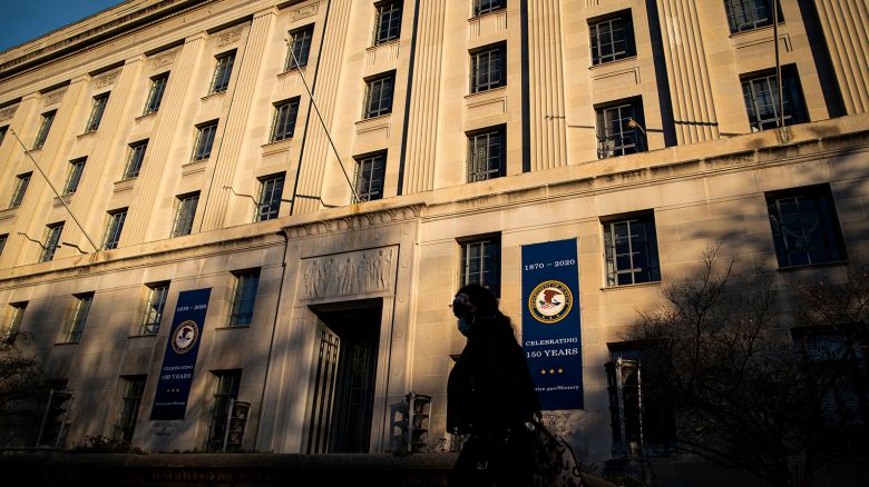 A woman walks past the U.S. Department of Justice Building, in Washington, U.S., December 15, 2020.