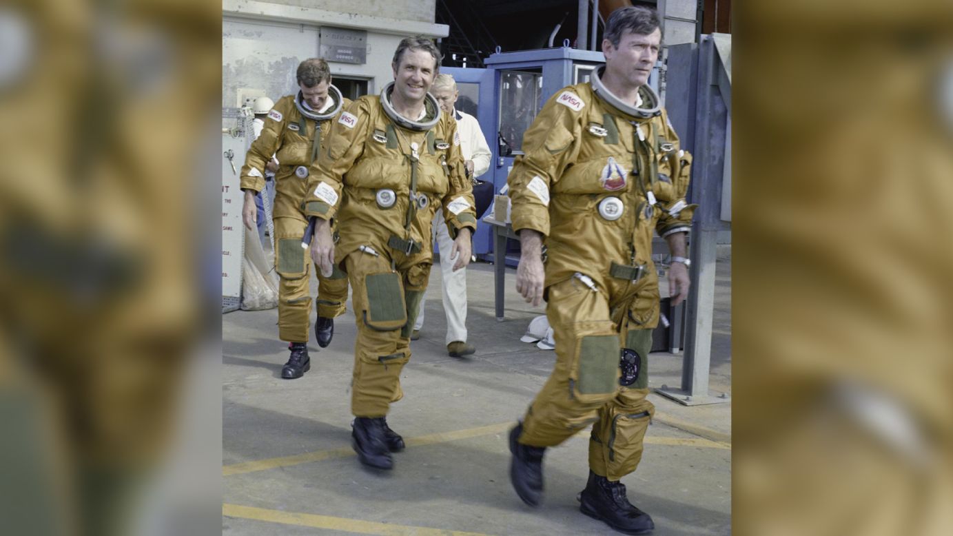 Space Shuttle prime and backup astronaut crews prepare to be briefed on the use of the emergency pad escape system, known as the "slidewire," in this photo from January 6, 1981. From left to right are backup astronauts Joe Engle and Richard Truly, and primary crew commander John Young. The slidewire system provided a quick and sure escape from the upper pad platforms in case of a serious emergency.