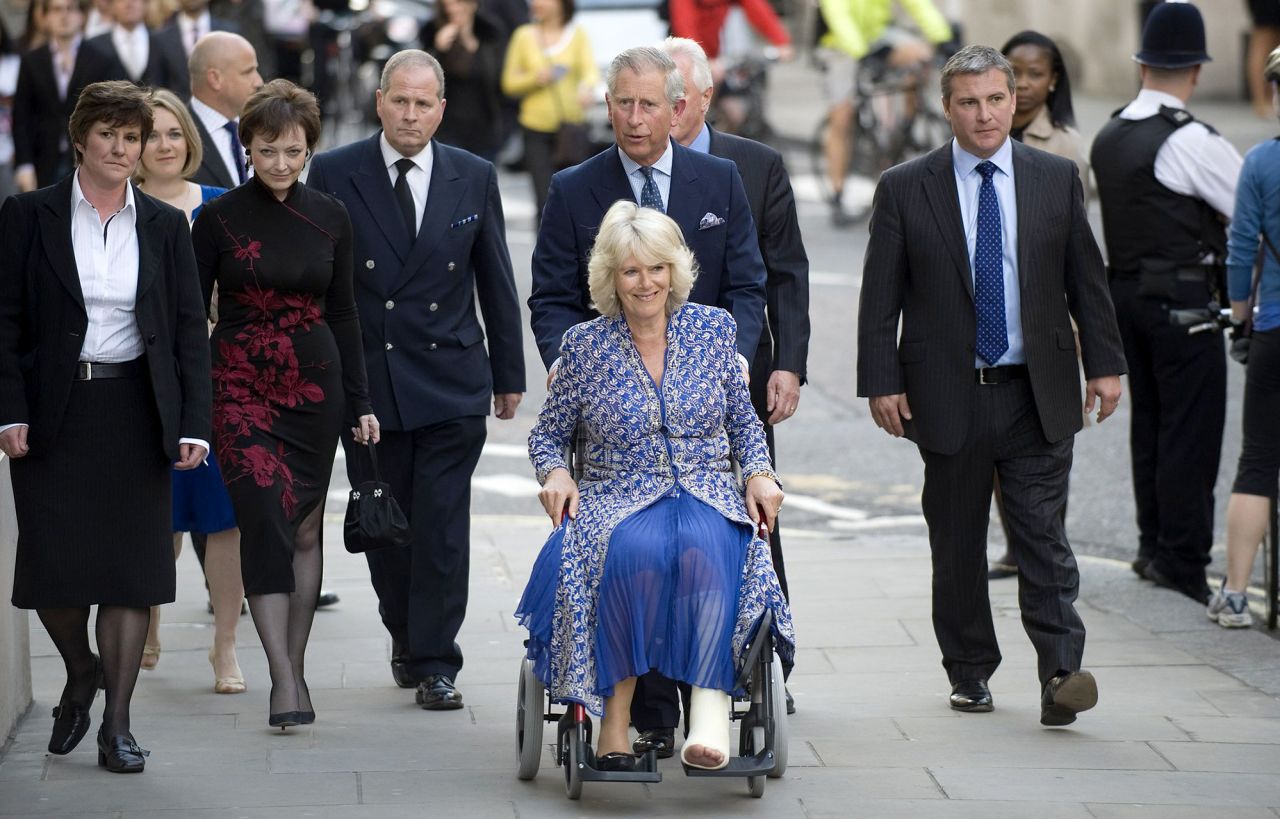 Charles pushes Camilla in a wheelchair as they attend the premiere of "Aida" at the Royal Opera House in London in April 2010. She had suffered a broken leg weeks prior.