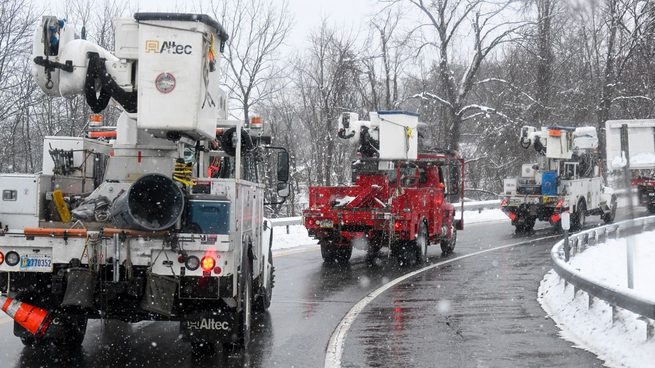 Utility repair crews in Albany, New York, caravan during Tuesday's storm.