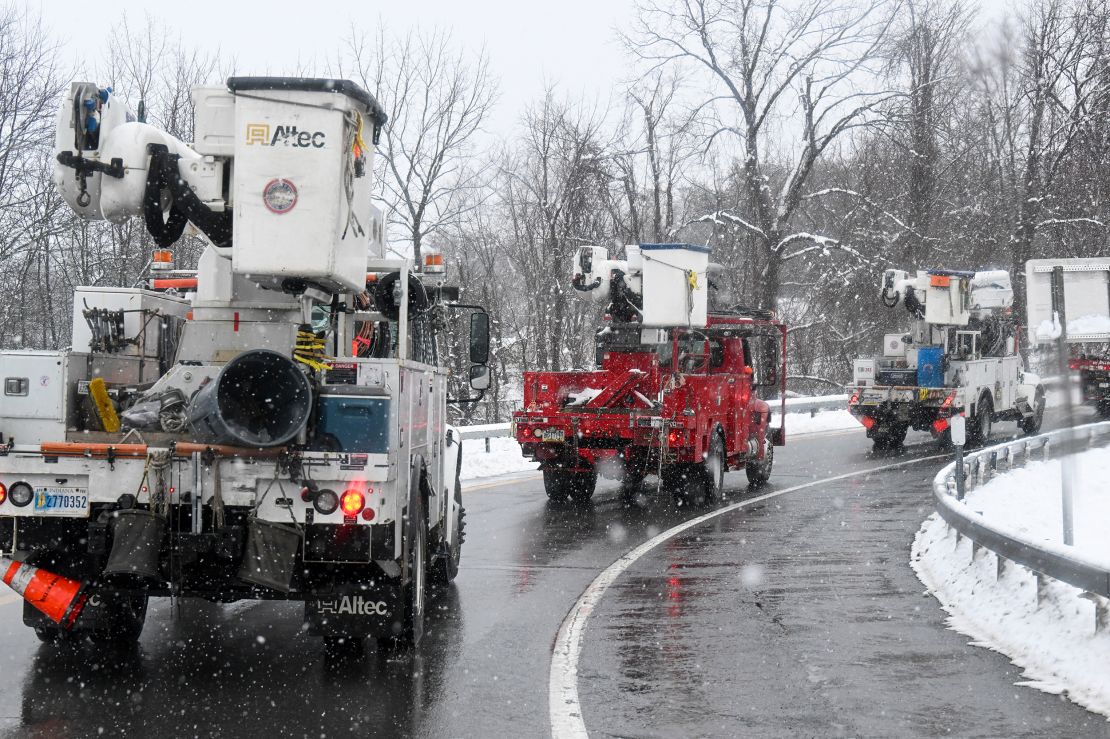 Utility repair crews in Albany, New York, caravan during Tuesday's storm.