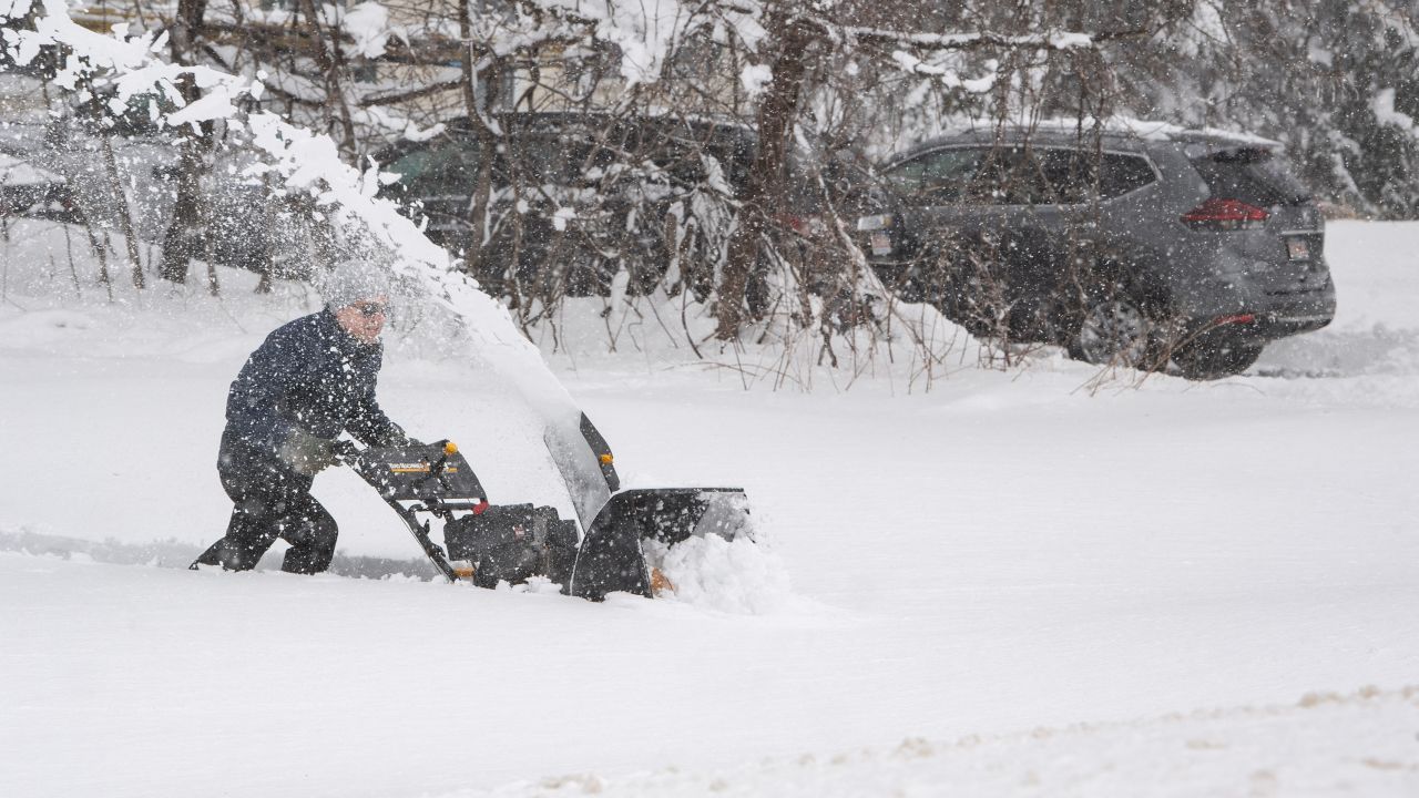 A person tries to use a snowblower to clear snow from a driveway in Rutland, Massachusetts, on Tuesday.