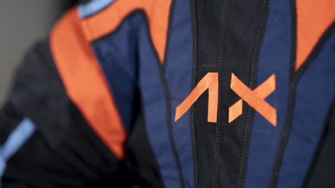 Axiom Space holds a contract to develop spacesuits for NASA's Artemis program, and has its logo and company colors printed on the top cover of the suit.