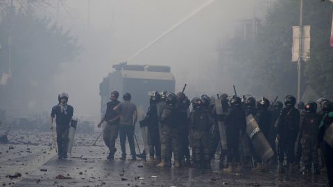 Police use water cannon to disperse supporters of former Prime Minister Imran Khan during clashes, in Lahore on March 15, 2023.