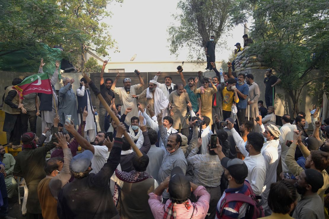 Supporters of former Prime Minister Imran Khan chant anti government slogans as they gather outside his residence, in Lahore on Wednesday.