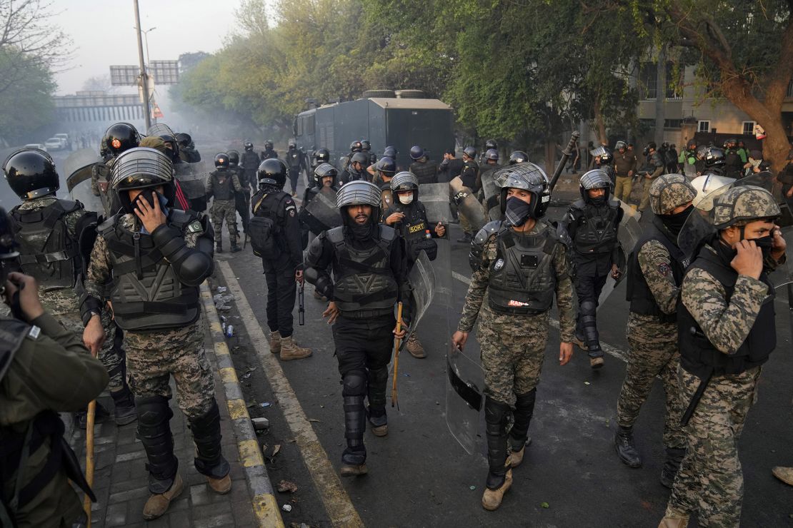 Paramilitary troops take position as riot police officer fire tear gas to disperse the supporters of Imran Khan. 