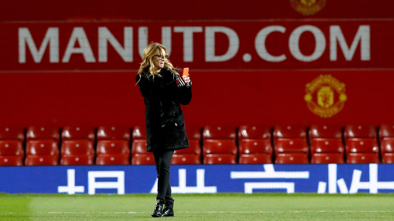 Julia Roberts takes photographs on the pitch after Manchester United's Premier League match at Old Trafford against West Ham. 