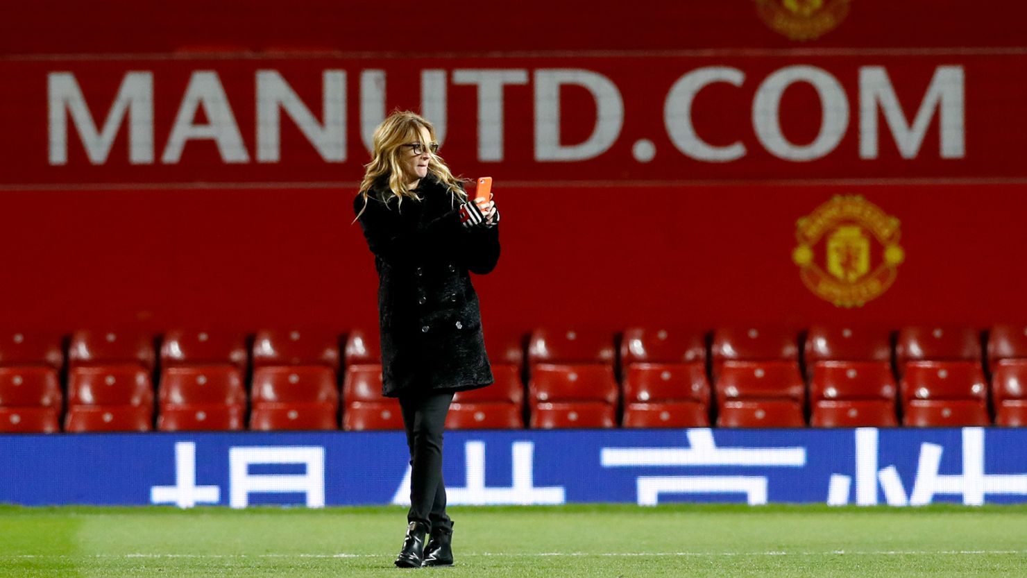 Julia Roberts takes photographs on the pitch after Manchester United's Premier League match at Old Trafford against West Ham. 
