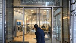 A man walks past a branch of Signature Bank in New York City on March 13, 2023. 