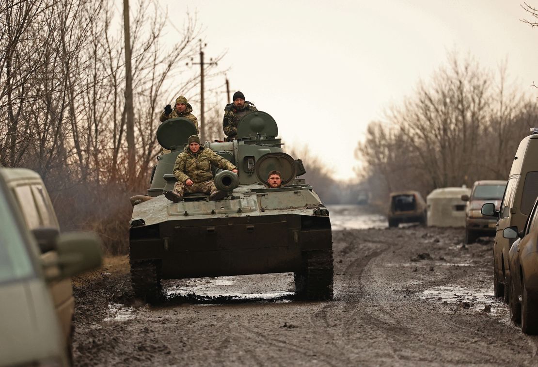 Ukrainian servicemen ride a 2C1 self-propelled howitzer along a road near Bakhmut on March 8.