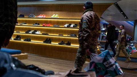 A soldier shops in a Kyiv mall, in December 2022. As the war grinds on, Ukraine's economy continues to suffer.  