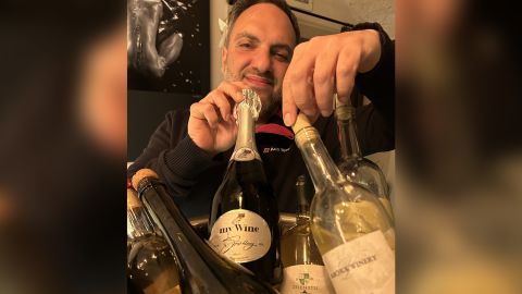 Ukrainian winemaker Eduard Gorodetsky with a selection of regional wines at his Odesa bar and wine shop. He says 