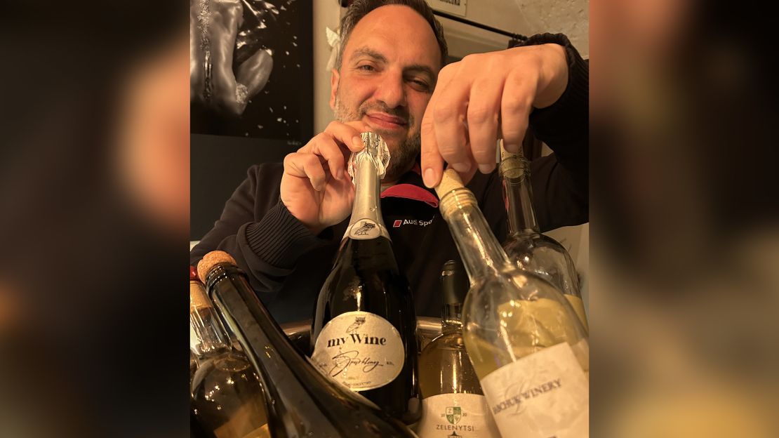 Ukrainian winemaker Eduard Gorodetsky with a selection of regional wines at his Odesa bar and wine shop. He says "buying Ukrainian" is seen as more affordable and patriotic. 