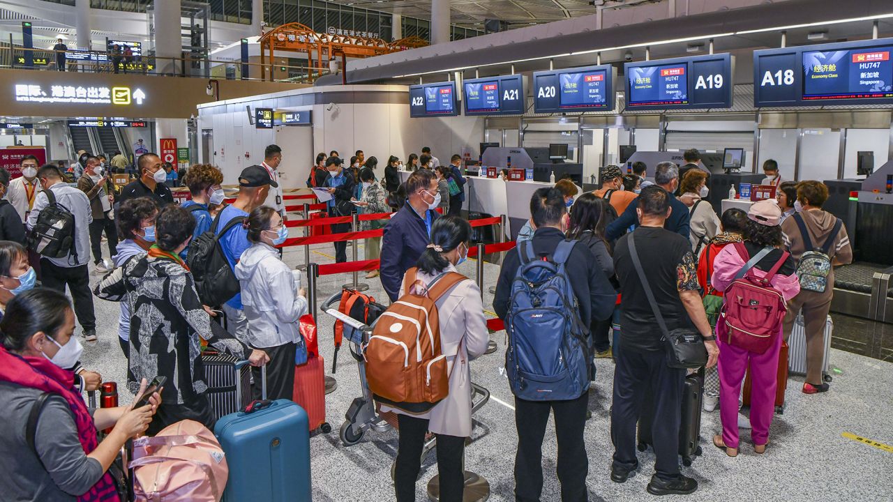 Passengers heading to Singapore checking in at Haikou Airport in China's Hainan province on March 15.