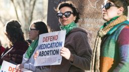 Lindsay London holds protest sign in front of federal court building in support of access to abortion medication outside the Federal Courthouse on Wednesday, March 15, 2023 in Amarillo, Texas. A conservative federal judge heard arguments Wednesday from a Christian group seeking to overturn the Food and Drug Administration's more than 2-decade-old approval of an abortion medication, in a case that could threaten the most common form of abortion in the U.S. (AP Photo/David Erickson)