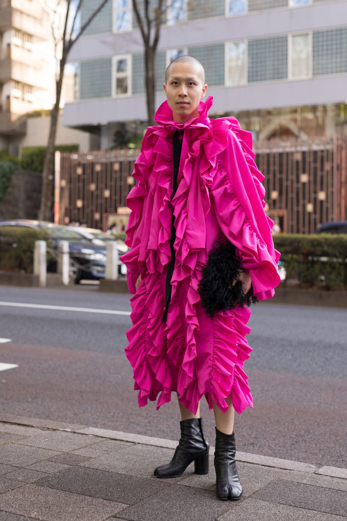 A guest outside Wednesday's HEoS show wearing a voluminous pink cape with ruffles.