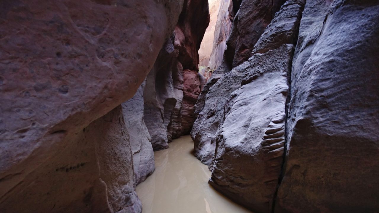 Two men are dead and one is hospitalized after being caught in a flash flood in the 16-mile-long slot canyon known as Buckskin Gulch in southern Utah.