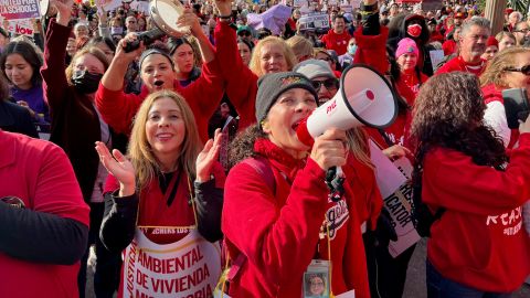 Sylvia Garcia from Bassett Street Elementary School speaks into a megaphone as she and hundreds of others attend a rally Wednesday at in downtown Los Angeles.