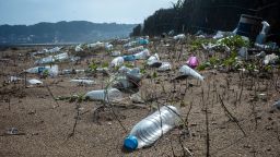 Disposed plastic water bottles blanket a beach in New Taipei, Taiwan in 2022. 