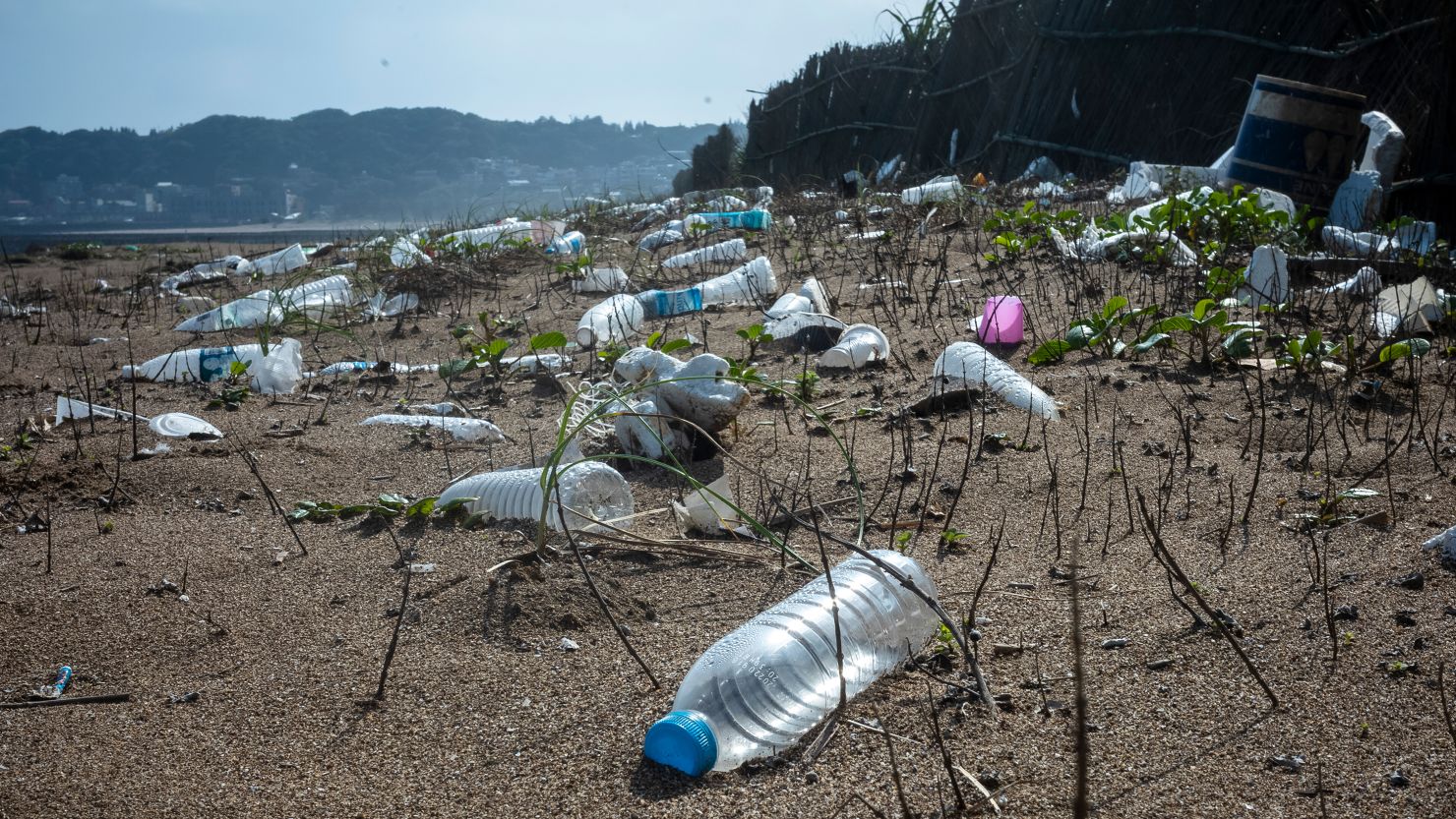Plastic water bottles blanket a beach in New Taipei, Taiwan in 2022. 