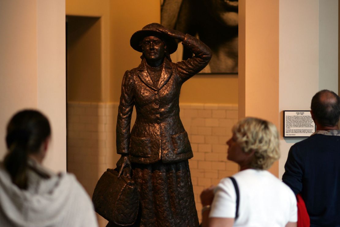 Visitors at Ellis Island in 2006 look at a statue that depicts Annie Moore, holding her hat in the harbor breeze. Ireland's president unveiled the statue in 1993.