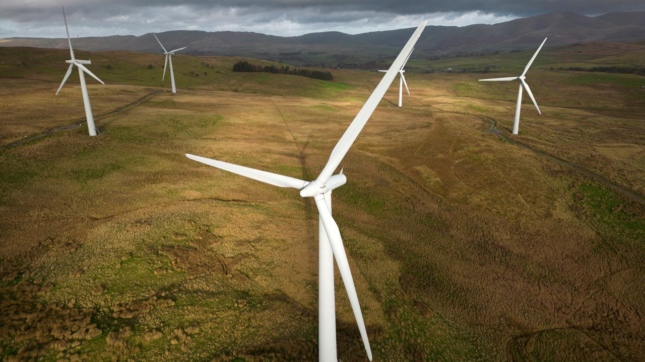 In this aerial view, wind turbines adorn the landscape in the Southern Lake District on November 25, 2022 in Lambrigg, England.