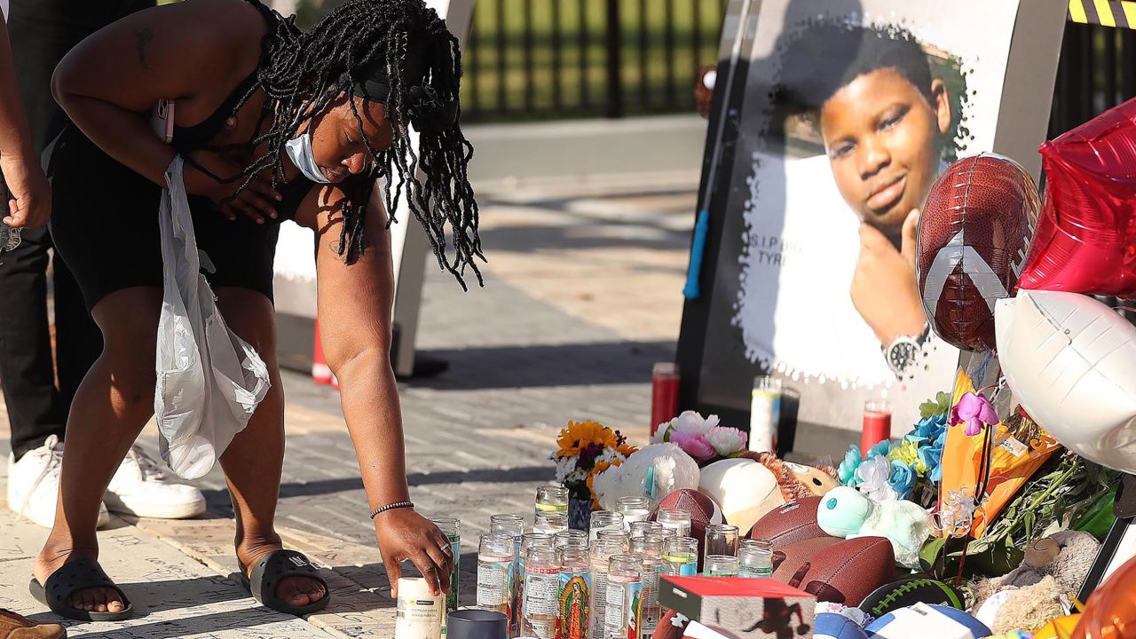 Family members and friends of Tyre Sampson leave items during a vigil in front of the drop tower on March 28, 2022.