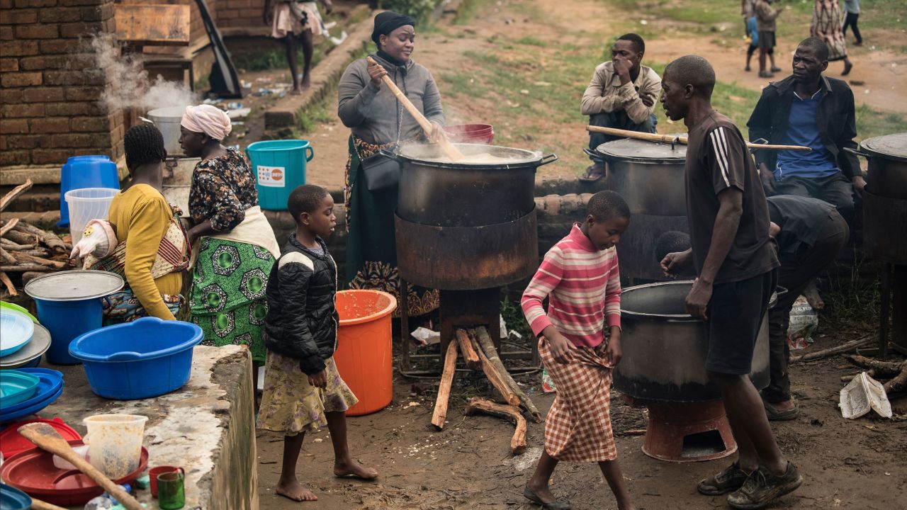 Community volunteers prepare meals for people who were displaced following heavy rains by tropical Cyclone Freddy in Blantyre, southern Malawi, Thursday, March 16, 2023. 